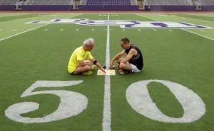 2016.07.26_Phil-Straus-Chris-Garlock-go-on-football-field-50-yard-line